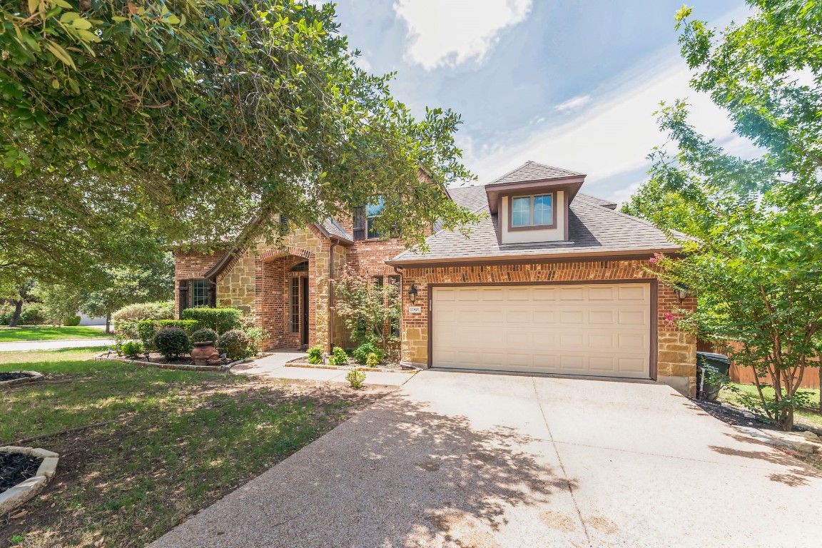 a front view of a house with a yard and garage