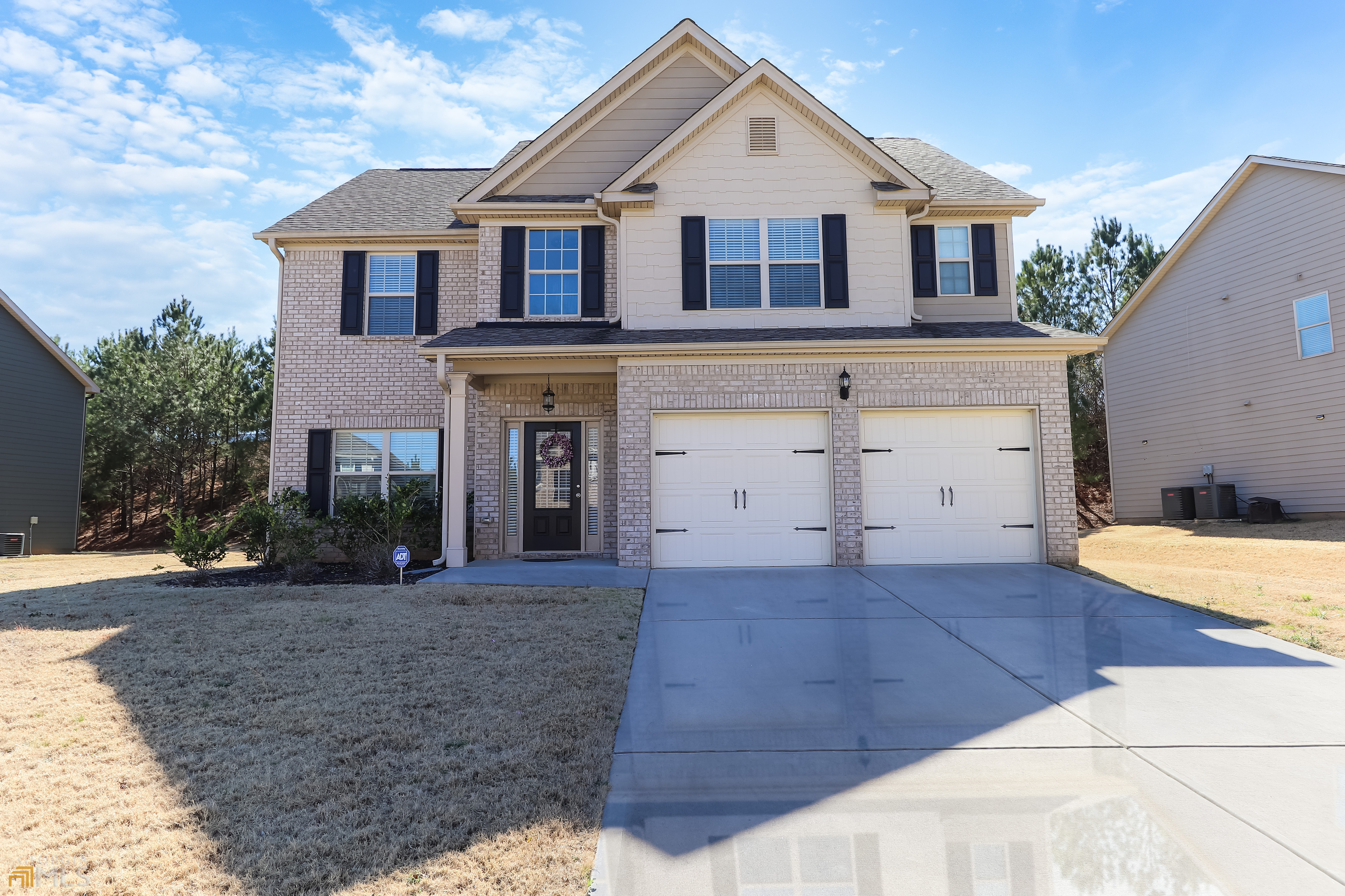 a front view of a house with a yard and garage