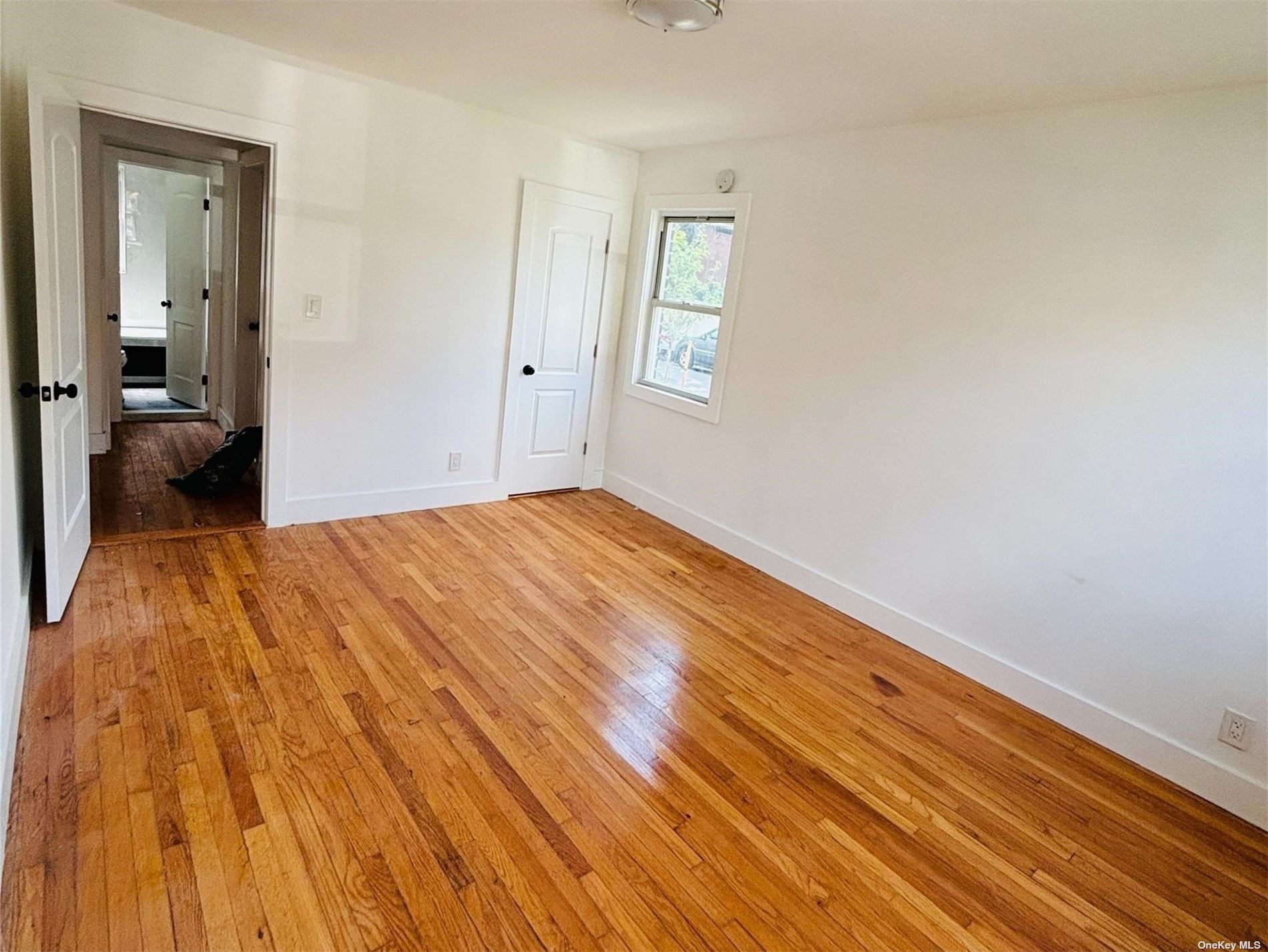 a view of a room with wooden floor and a bathroom