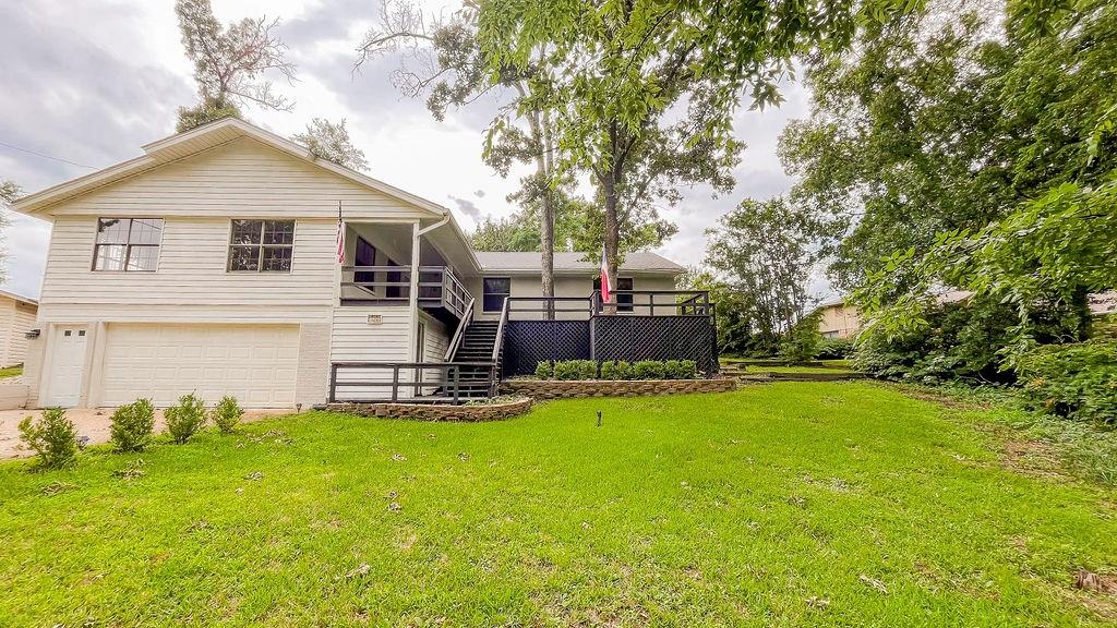 a view of a house with backyard and sitting area