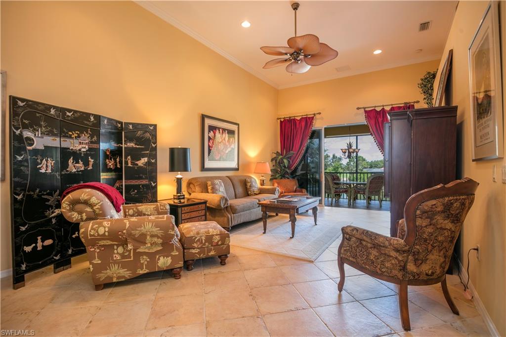 a living room with furniture a ceiling fan and a rug