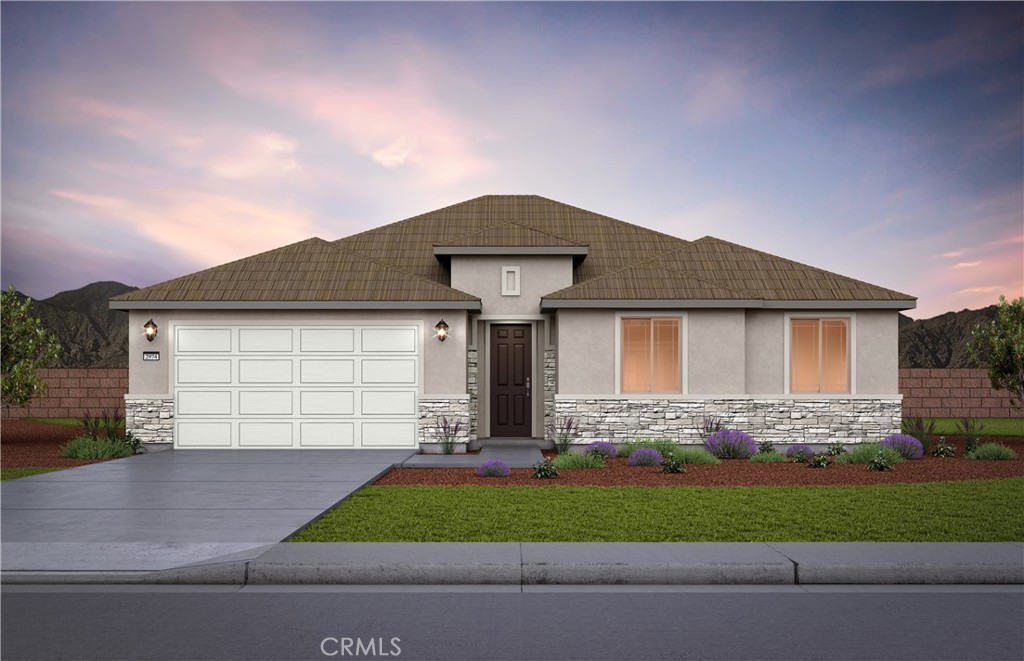 a front view of a house with a garden and garage