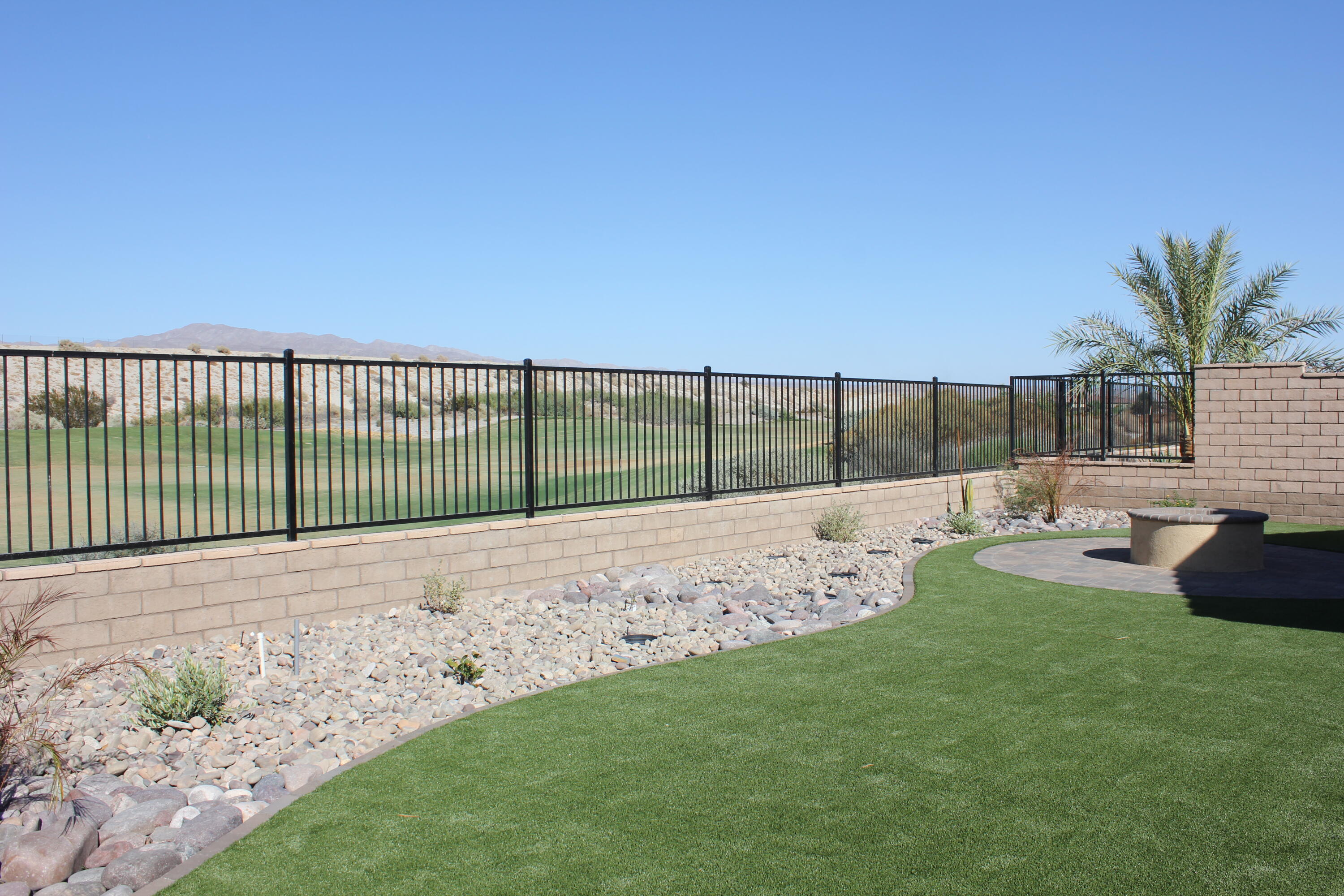 a view of a backyard with a garden and entertaining space