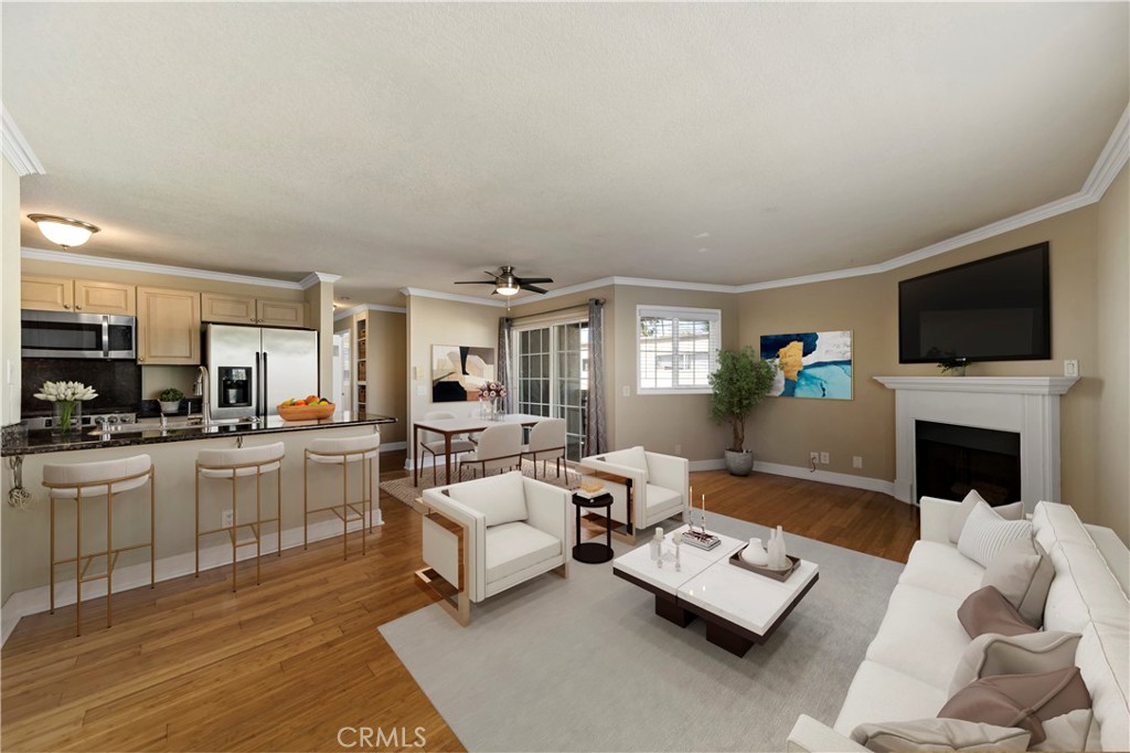 a living room with furniture a fireplace and a flat screen tv