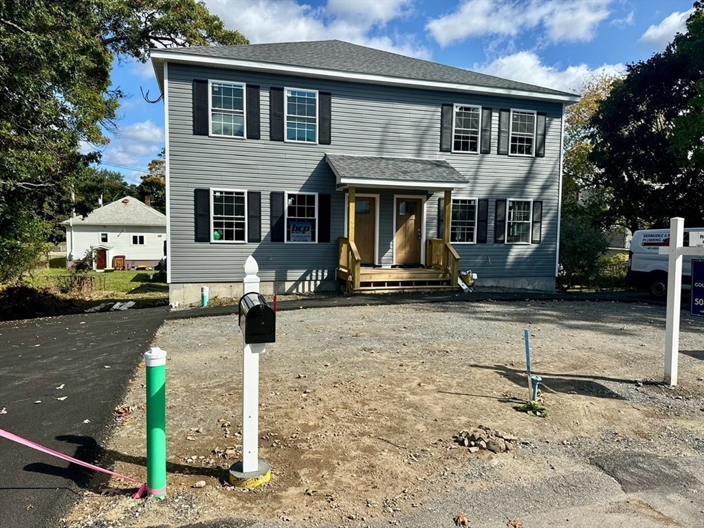 a front view of a house with parking area