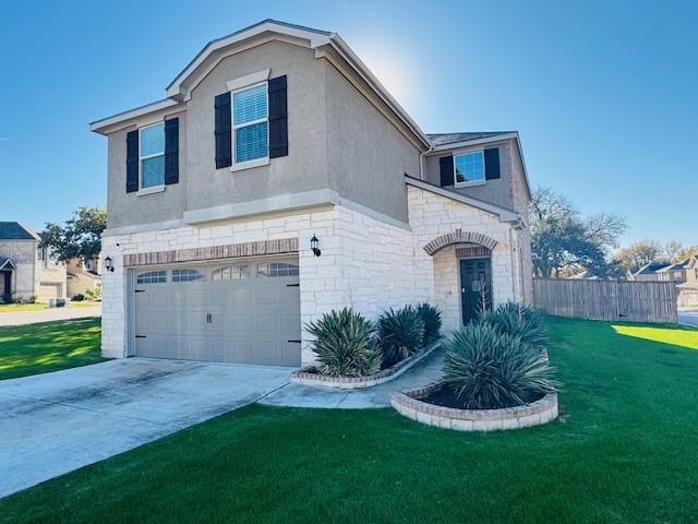 a front view of a house with a yard and garage