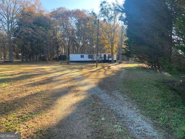 a view of a yard with large trees