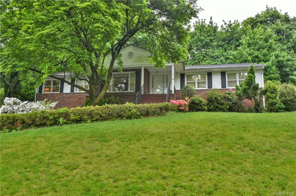 a front view of house with yard and green space