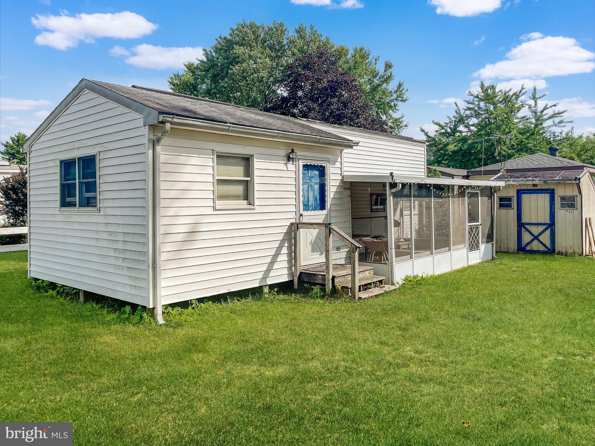 a view of a house with a yard and deck