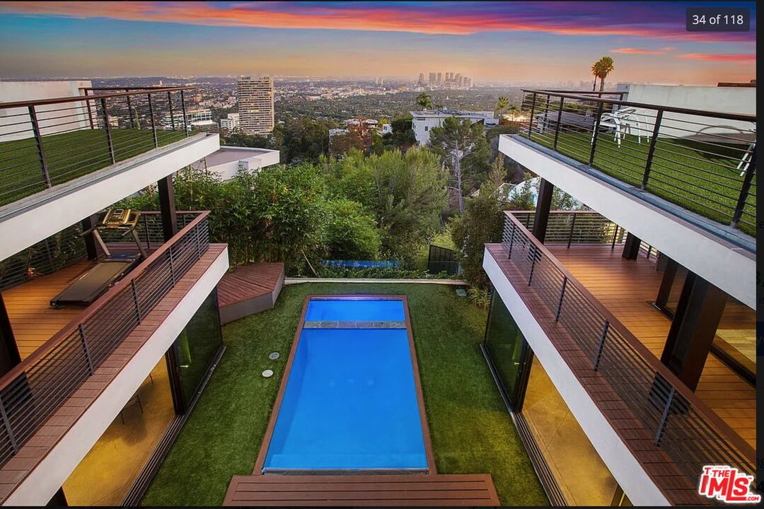 a balcony with wooden floor and city view