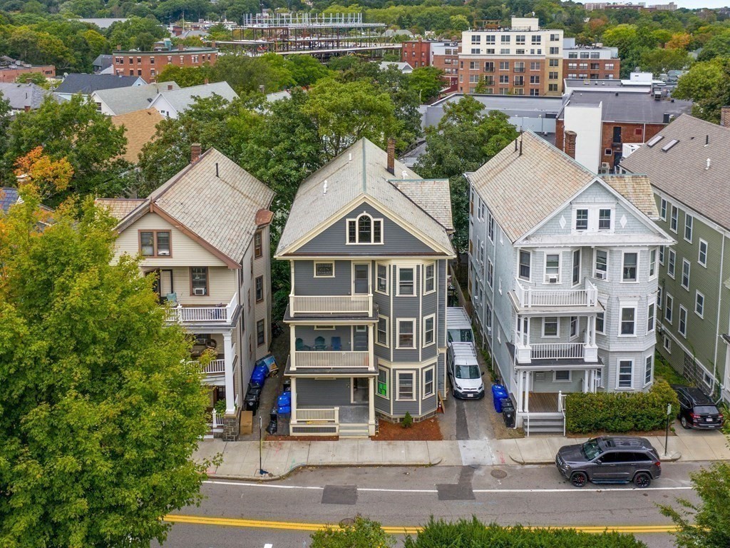 a aerial view of a brick building next to a yard