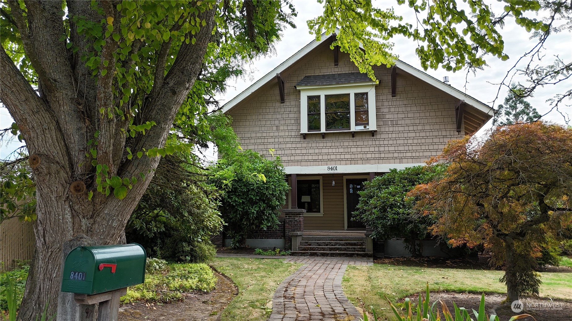 a house that has a tree in front of the house