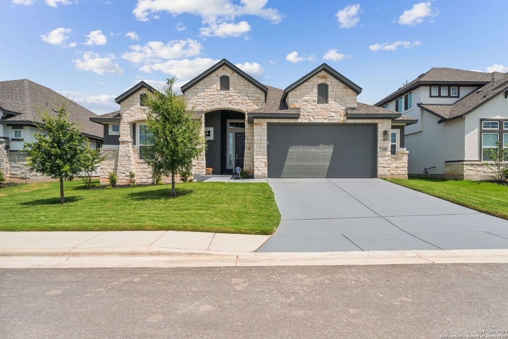 a front view of a house with a yard and garage