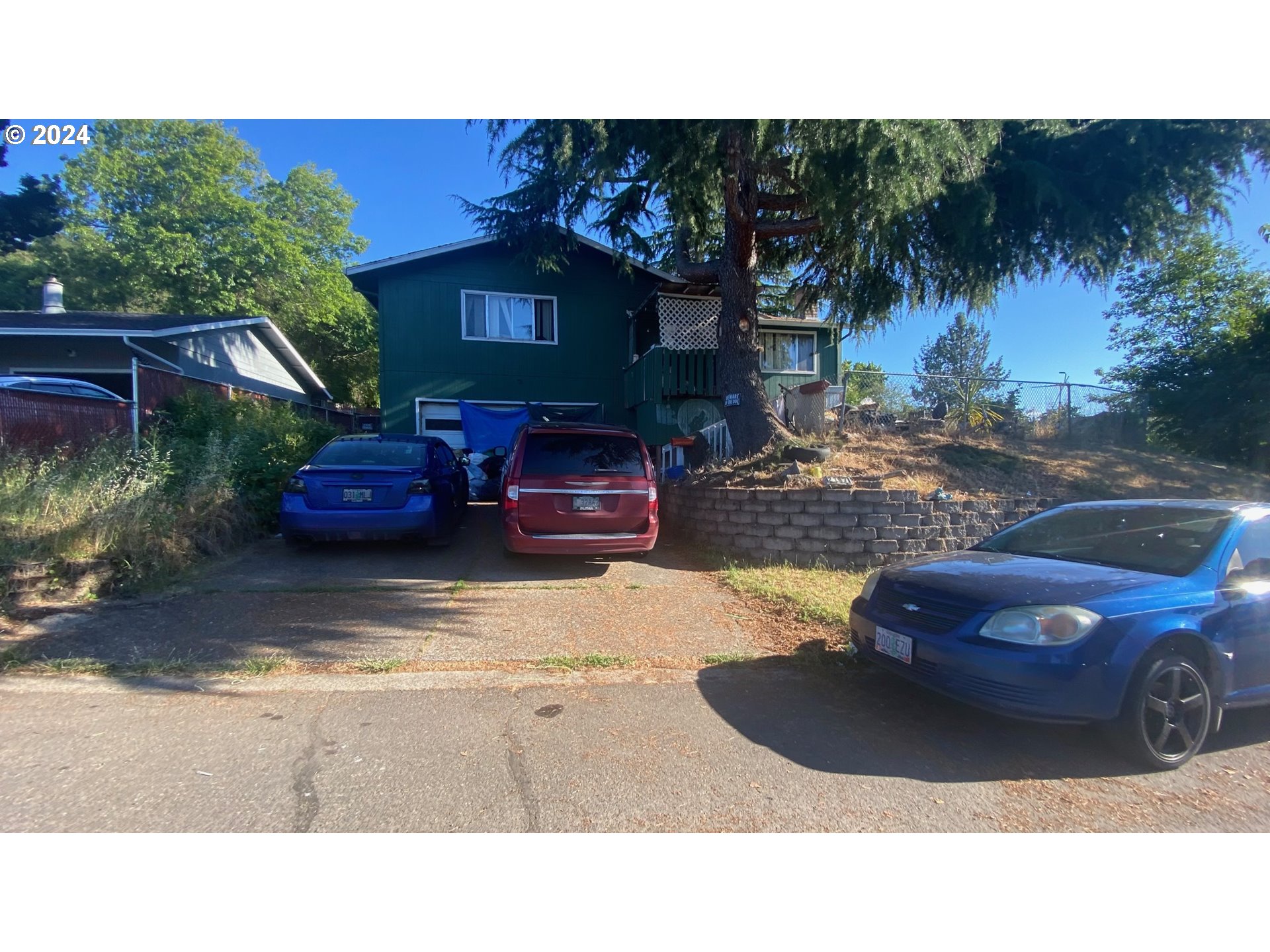 a couple of cars parked in front of a house