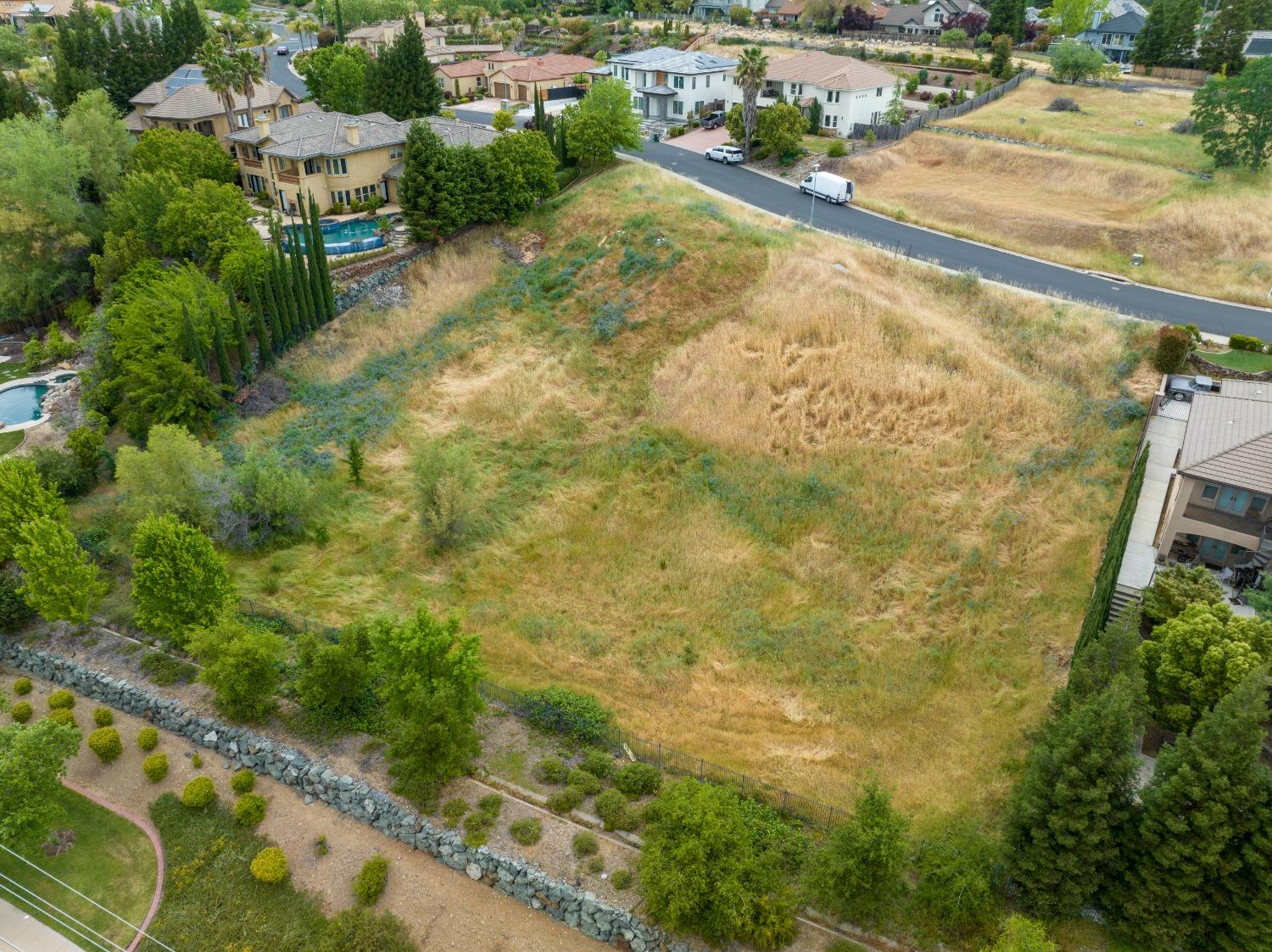 an aerial view of residential houses with yard