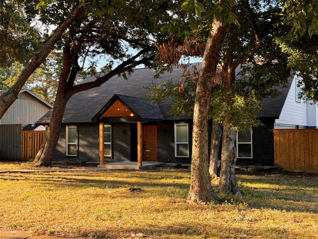 a view of a house with a large tree