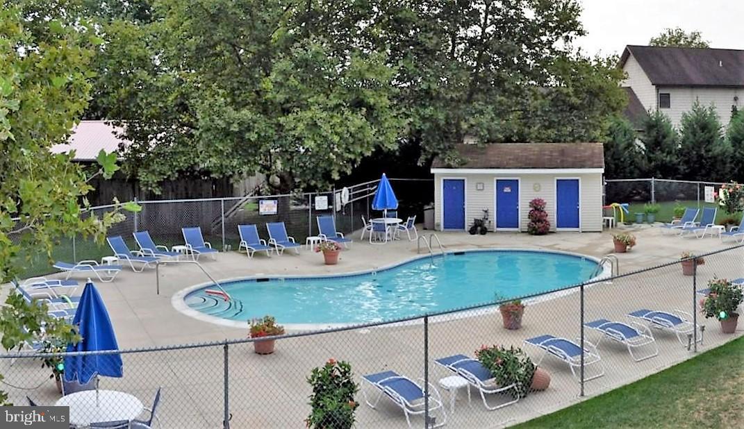 swimming pool view with a seating space