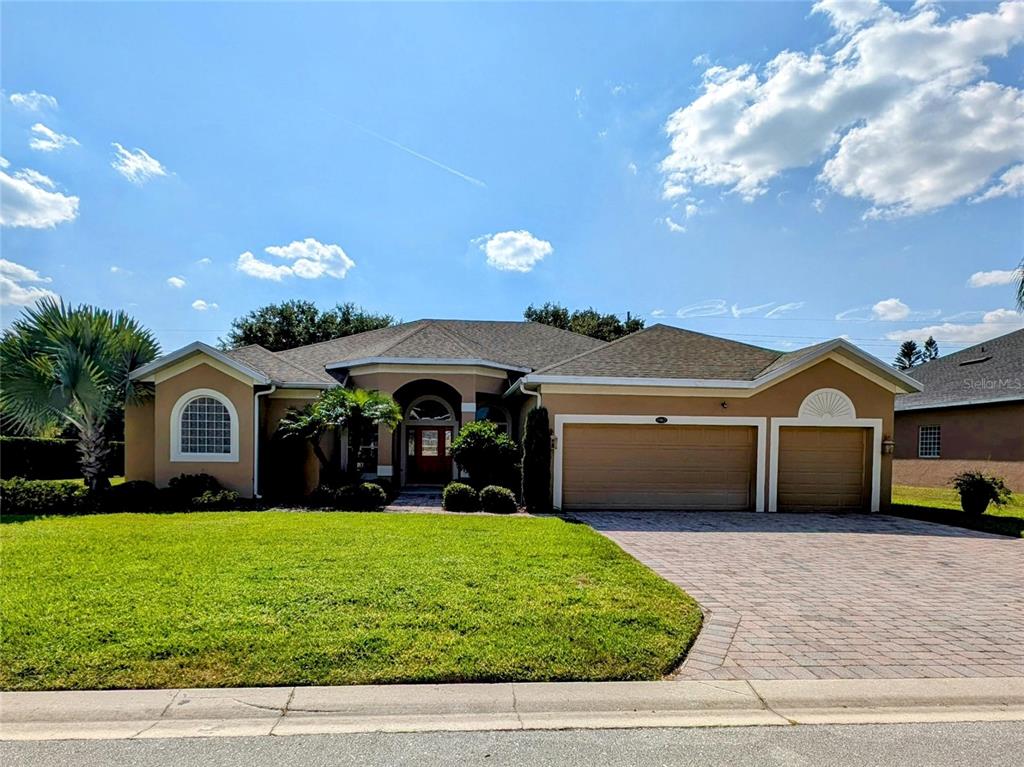 a front view of a house with a yard and garage