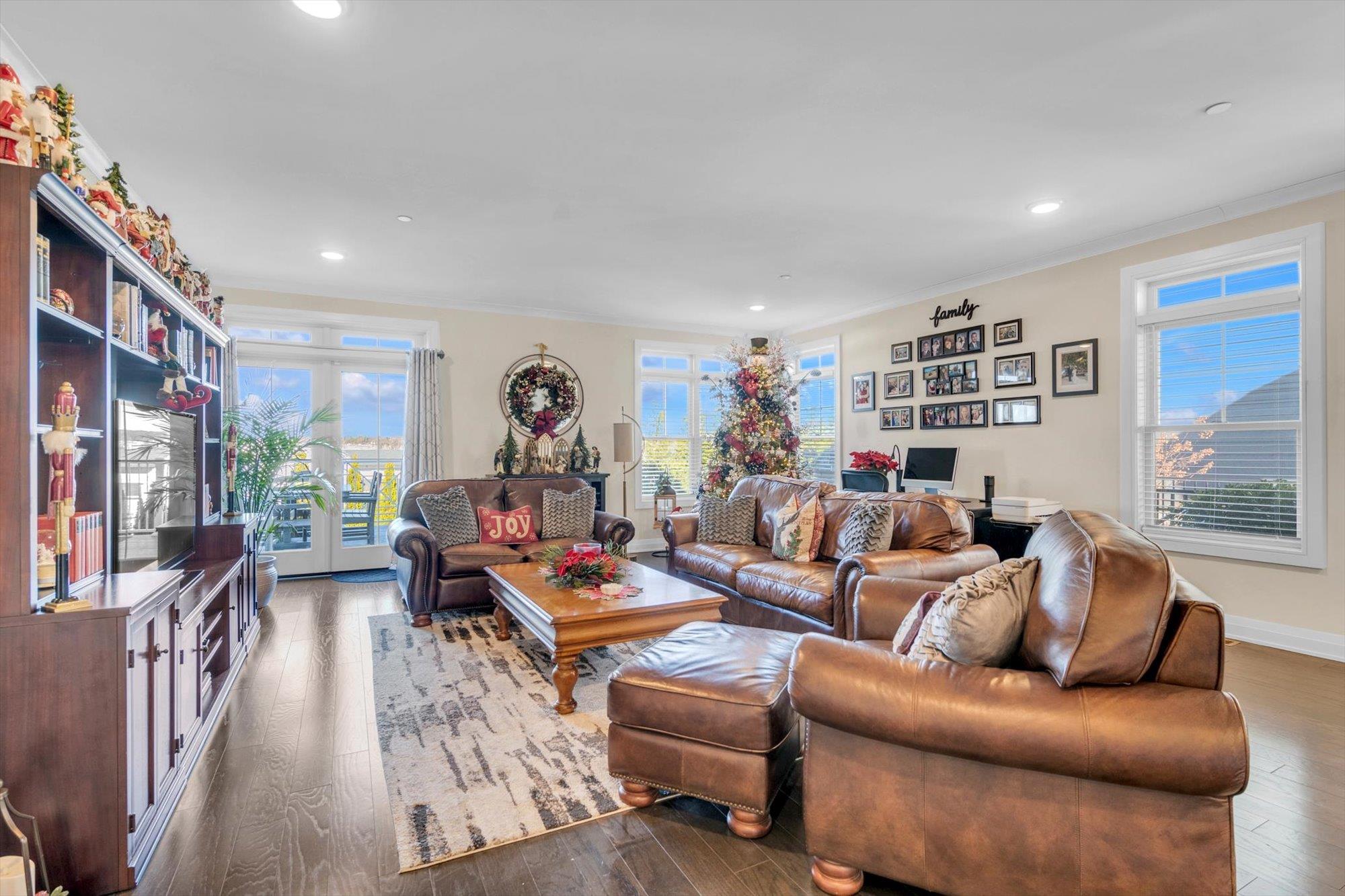 a living room with furniture fireplace and a large window