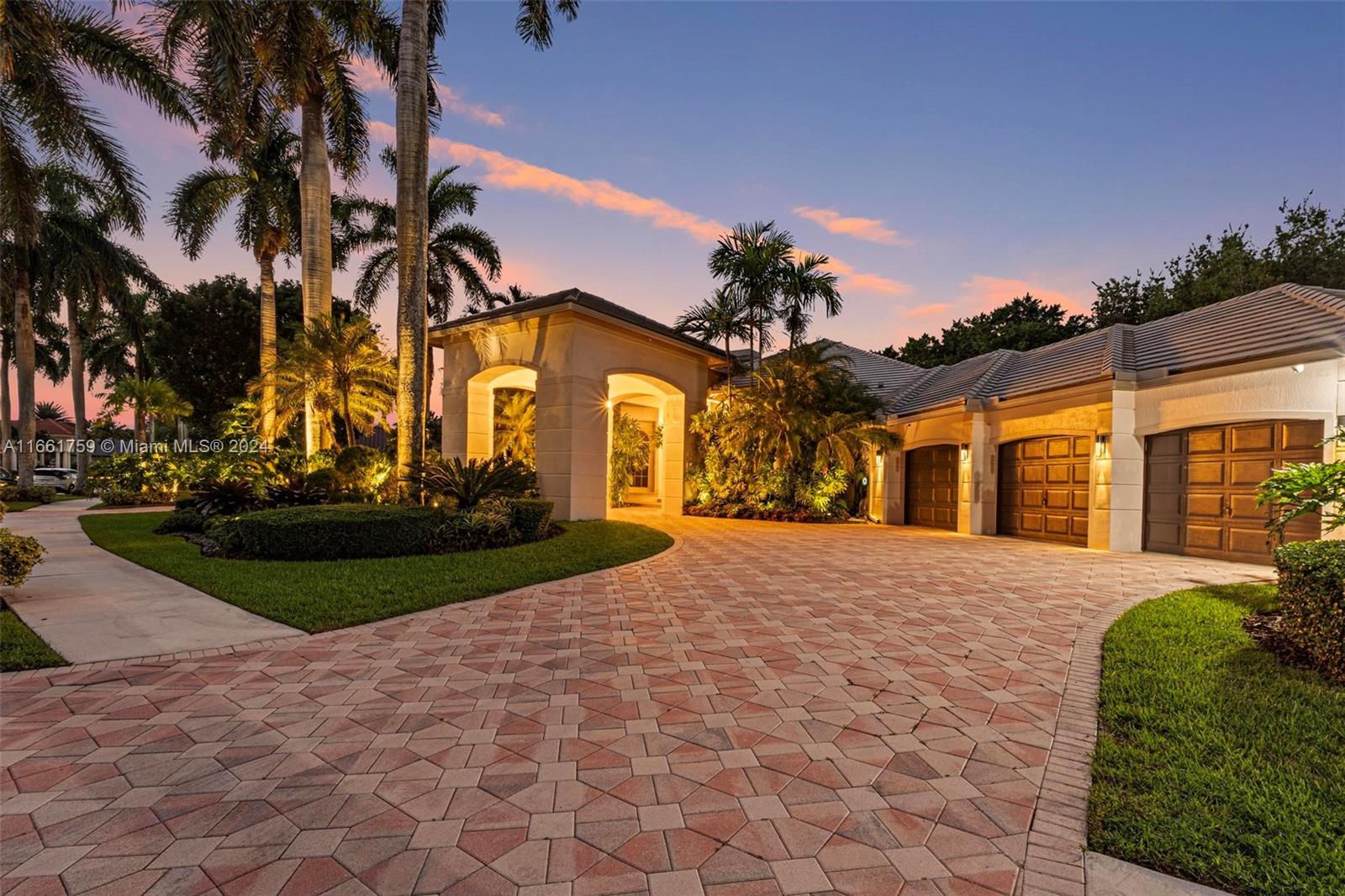 a front view of a house with a yard and a garage