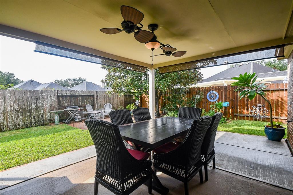 Outside you will find a covered patio with a ceiling fan.