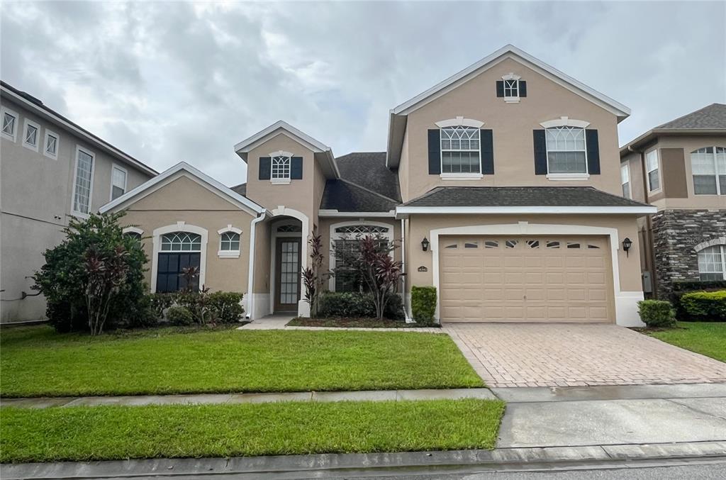 a front view of a house with a yard and garage