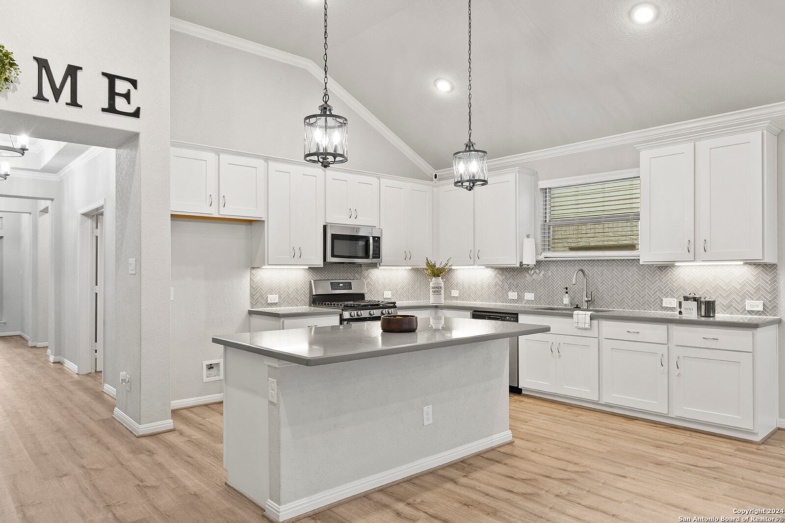 a kitchen with stainless steel appliances a sink stove and refrigerator