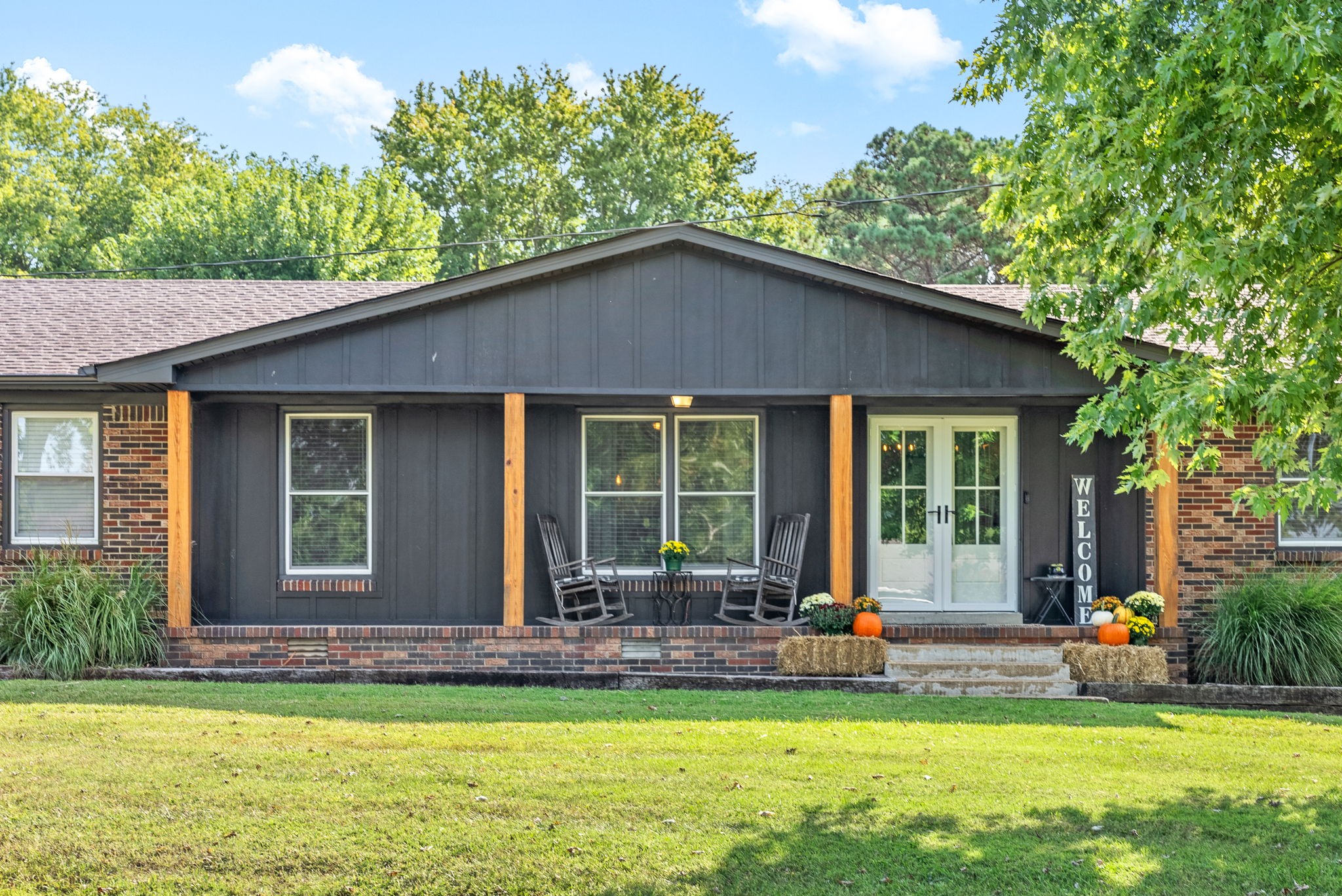 a front view of house with yard and outdoor seating