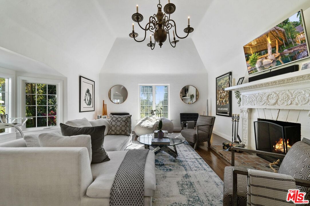 a living room with furniture a fireplace and a window