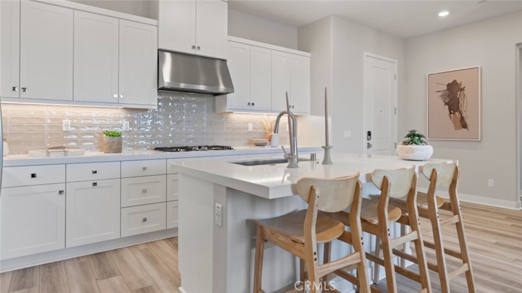 a kitchen with stainless steel appliances granite countertop white cabinets a sink and dishwasher