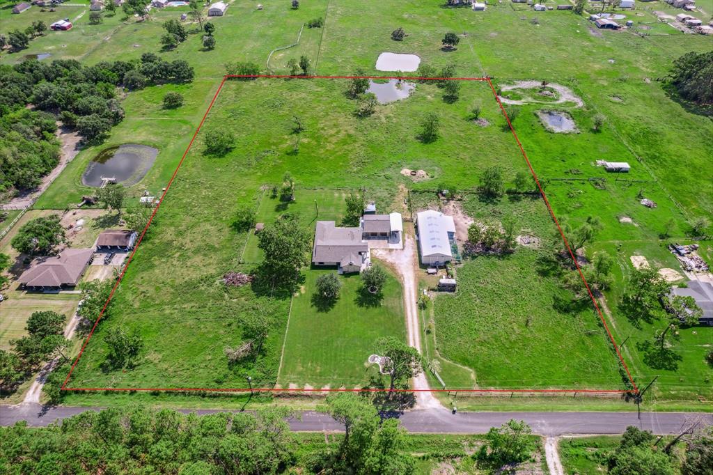 an aerial view of residential houses with outdoor space and street view