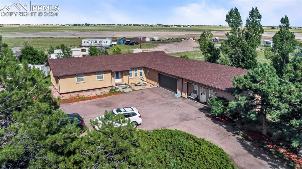 an aerial view of a house with garden space and a lake view