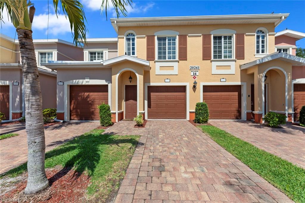 a front view of a house with yard and outdoor seating