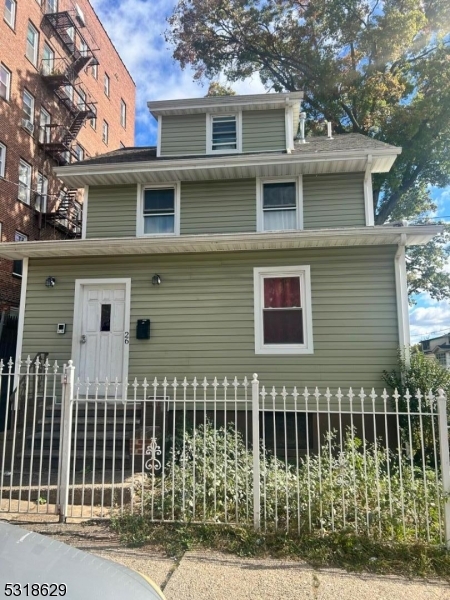 a front view of a house with a fence