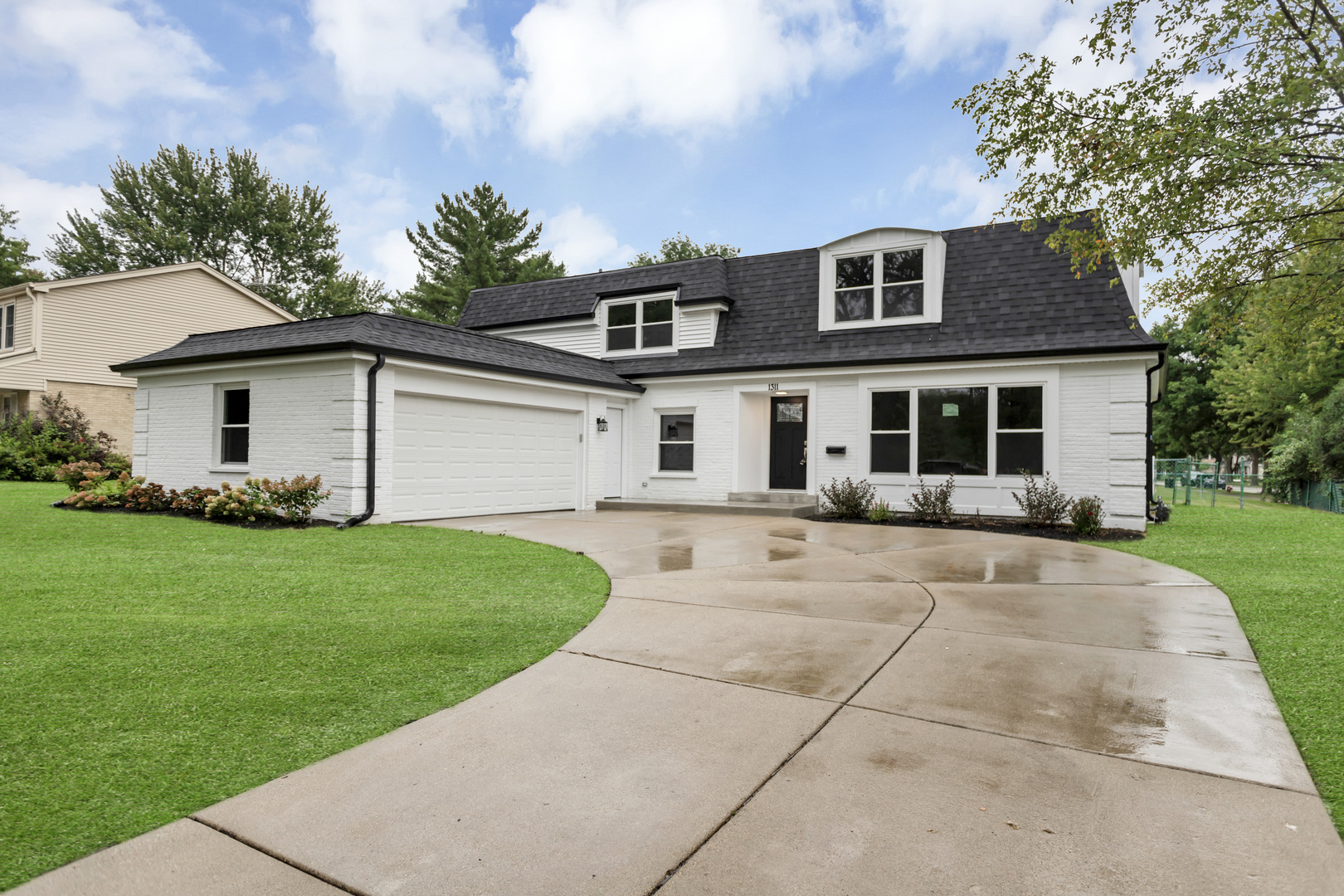 a front view of house with yard and green space