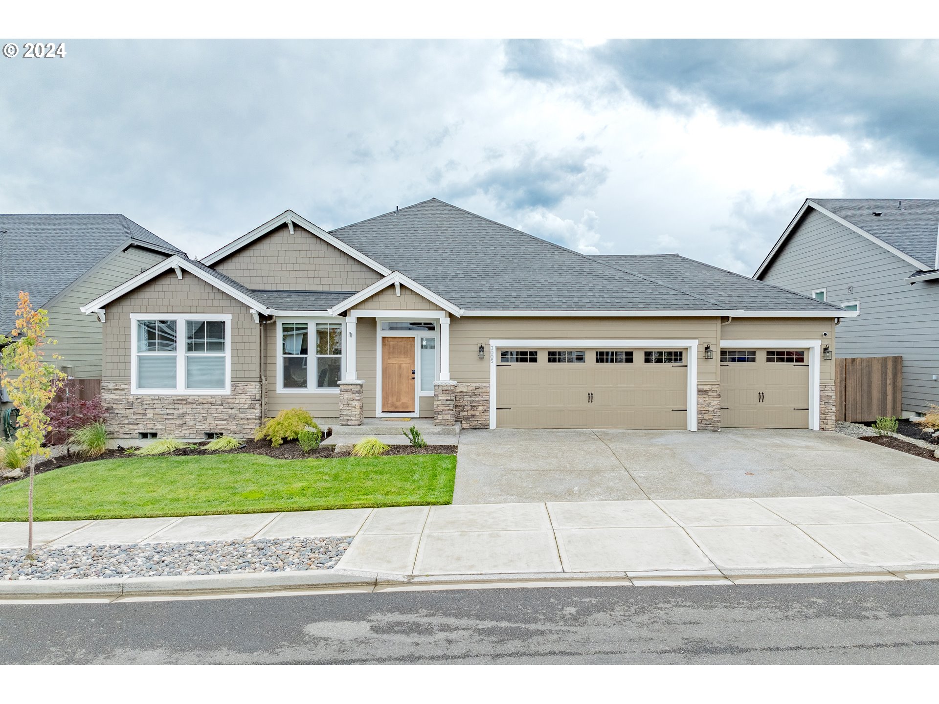 a front view of a house with a yard and garage