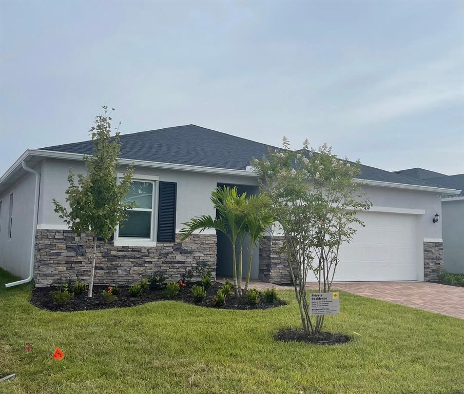 a front view of house with a garden