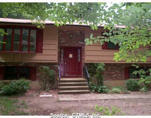 a front view of a house with plants