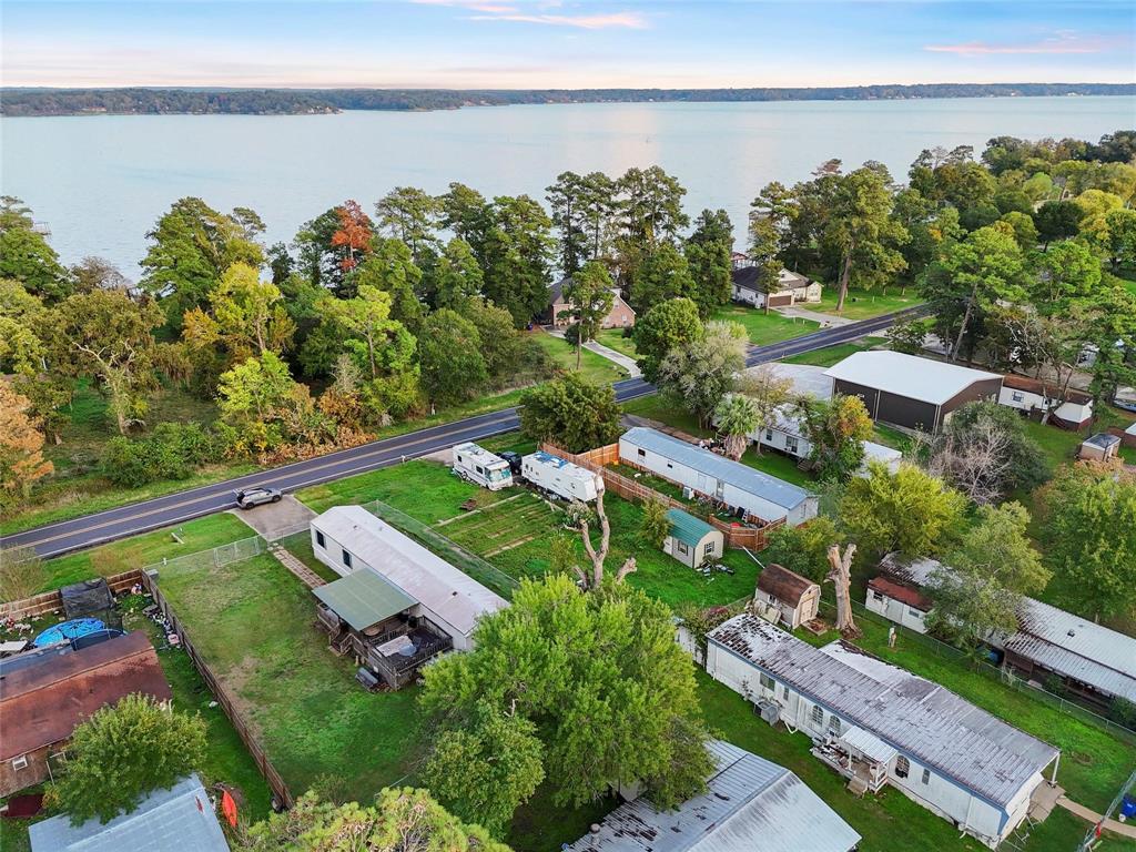 an aerial view of a house with a garden and lake view