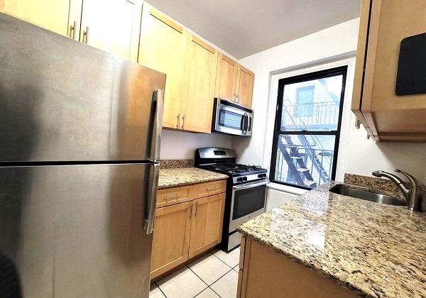 a kitchen with a refrigerator stove and sink