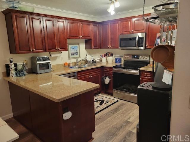 a kitchen with kitchen island granite countertop a sink dishwasher stove and wooden cabinets