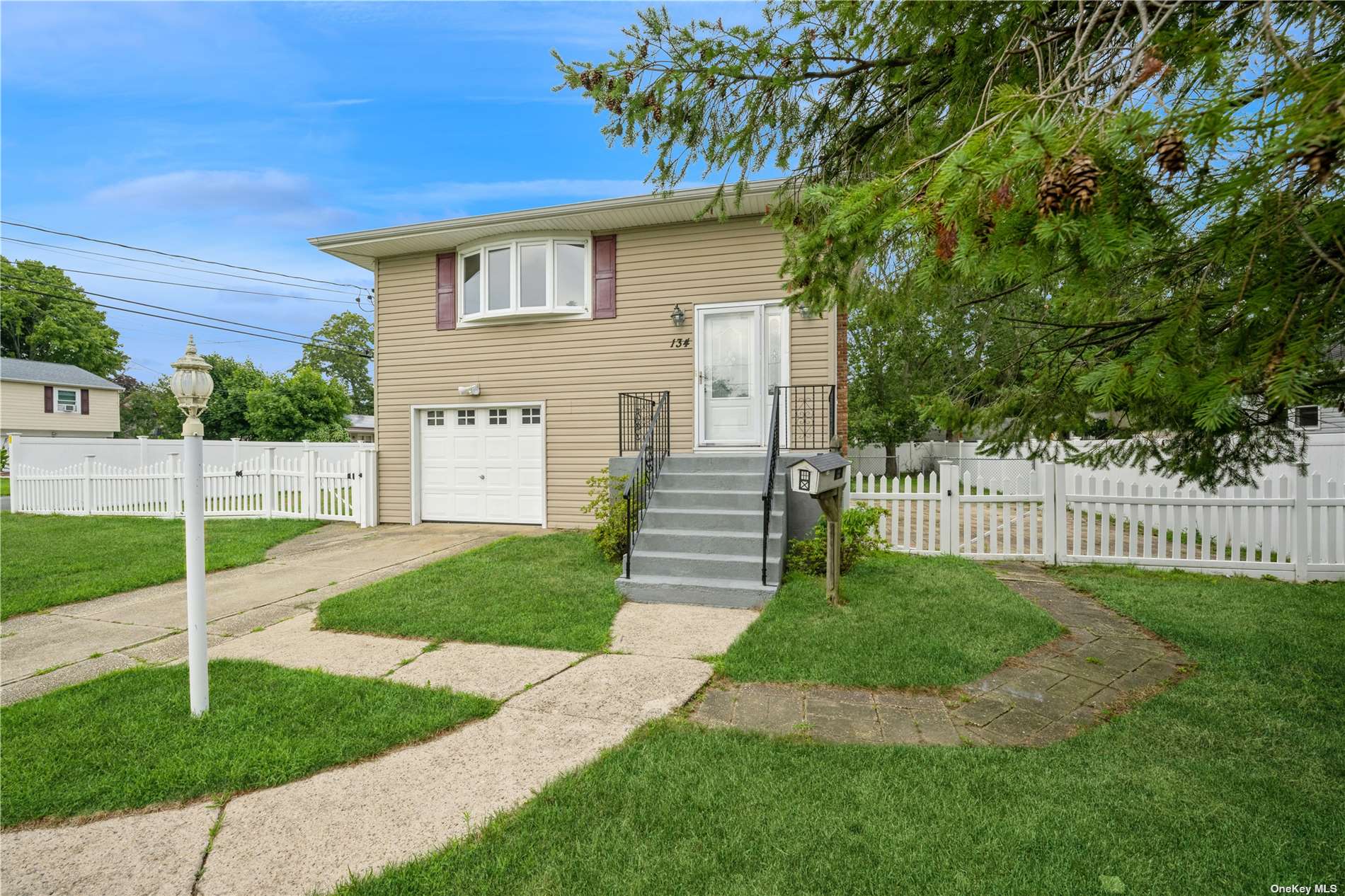 a view of a house with a yard and large tree