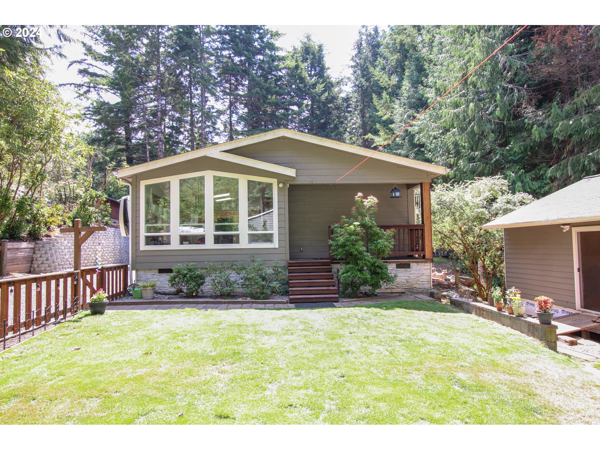 a front view of a house with a garden and patio