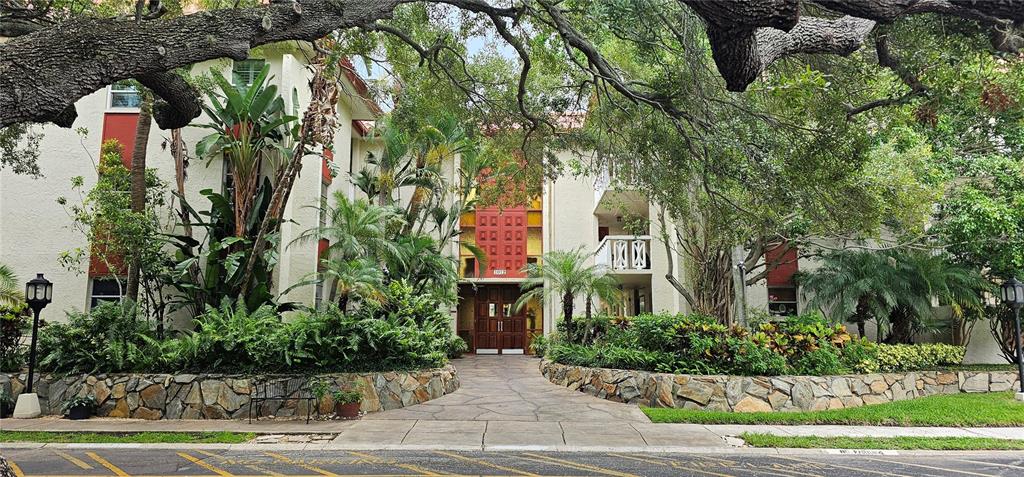 a front view of multi story residential apartment building with yard