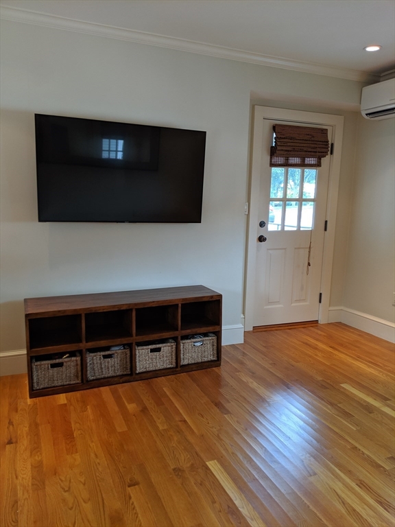 a living room with flat screen tv and fireplace