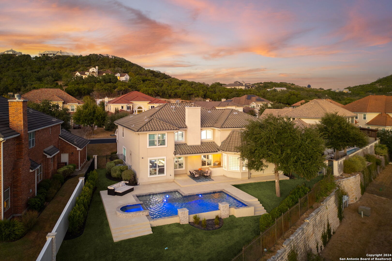 an aerial view of residential houses with outdoor space and river