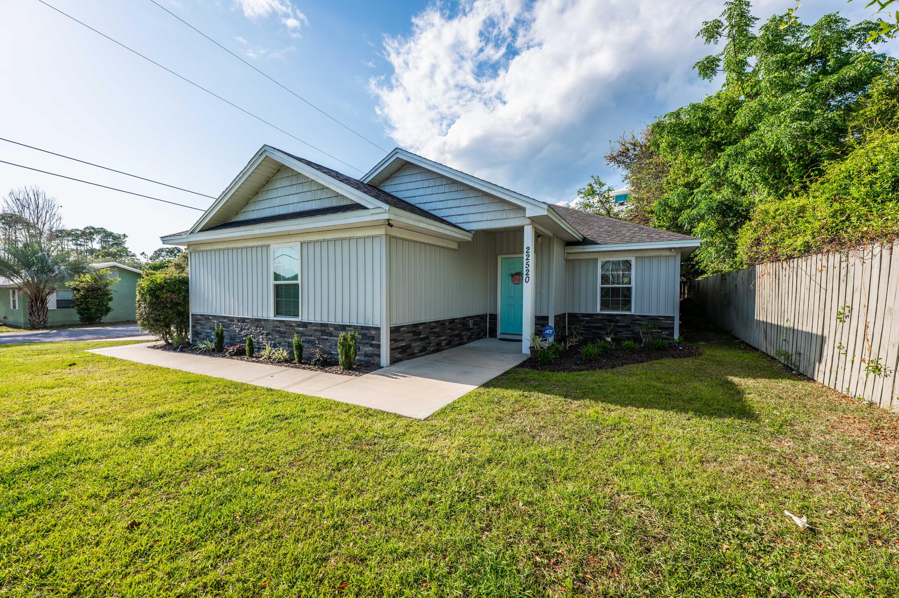 a view of a house with a yard and a patio