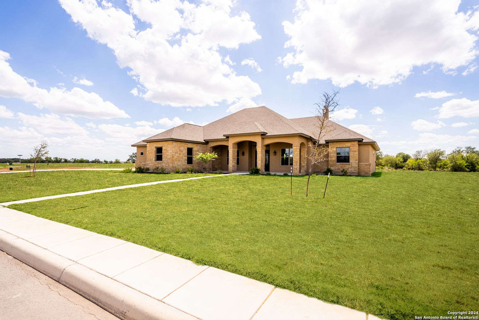 a front view of a house with a big yard