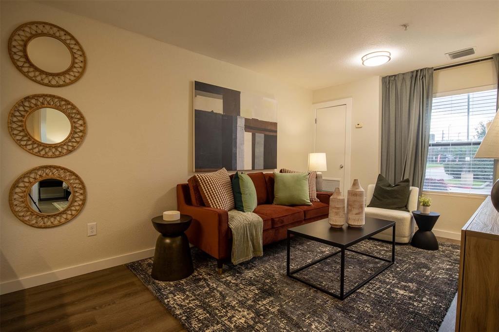 a living room with furniture a window and a lamp