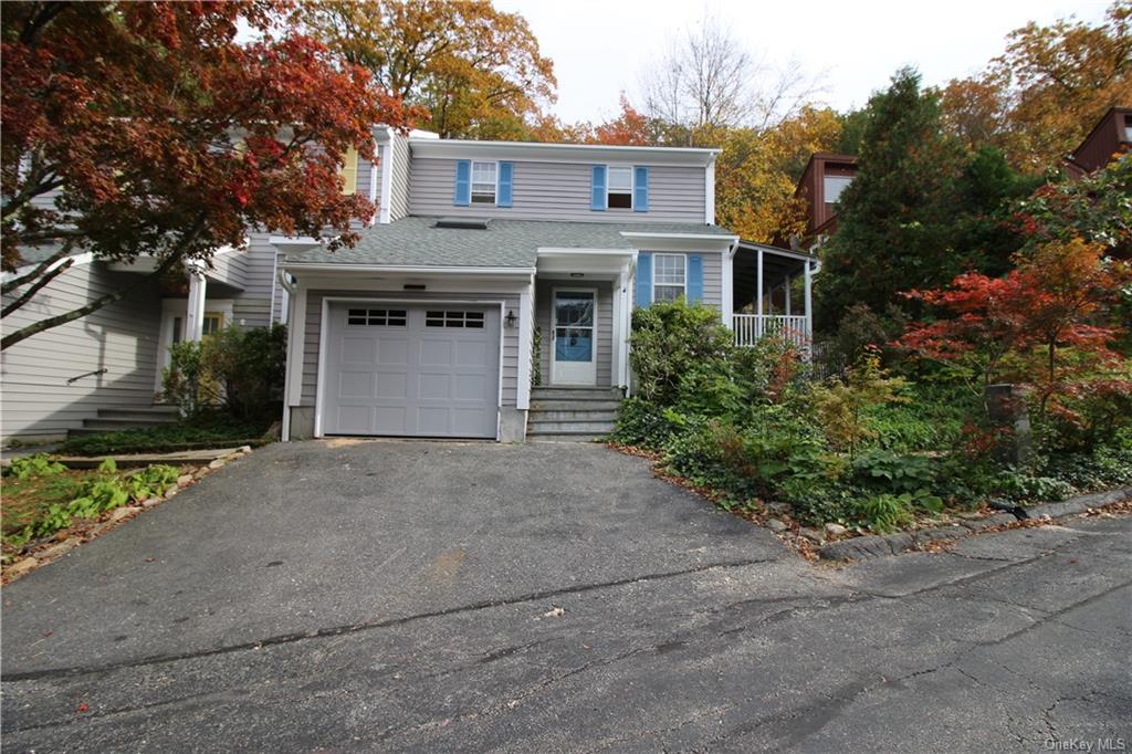 front view of a house with a yard and a garage